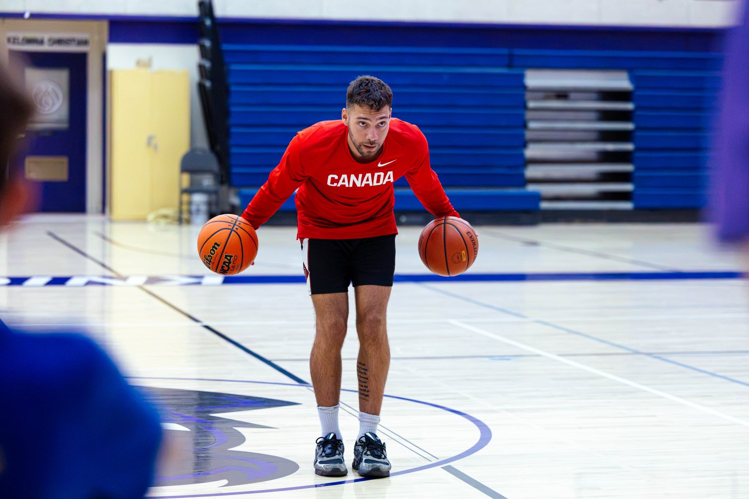 Jadon Cohee handling two basketballs in his Canada warm up