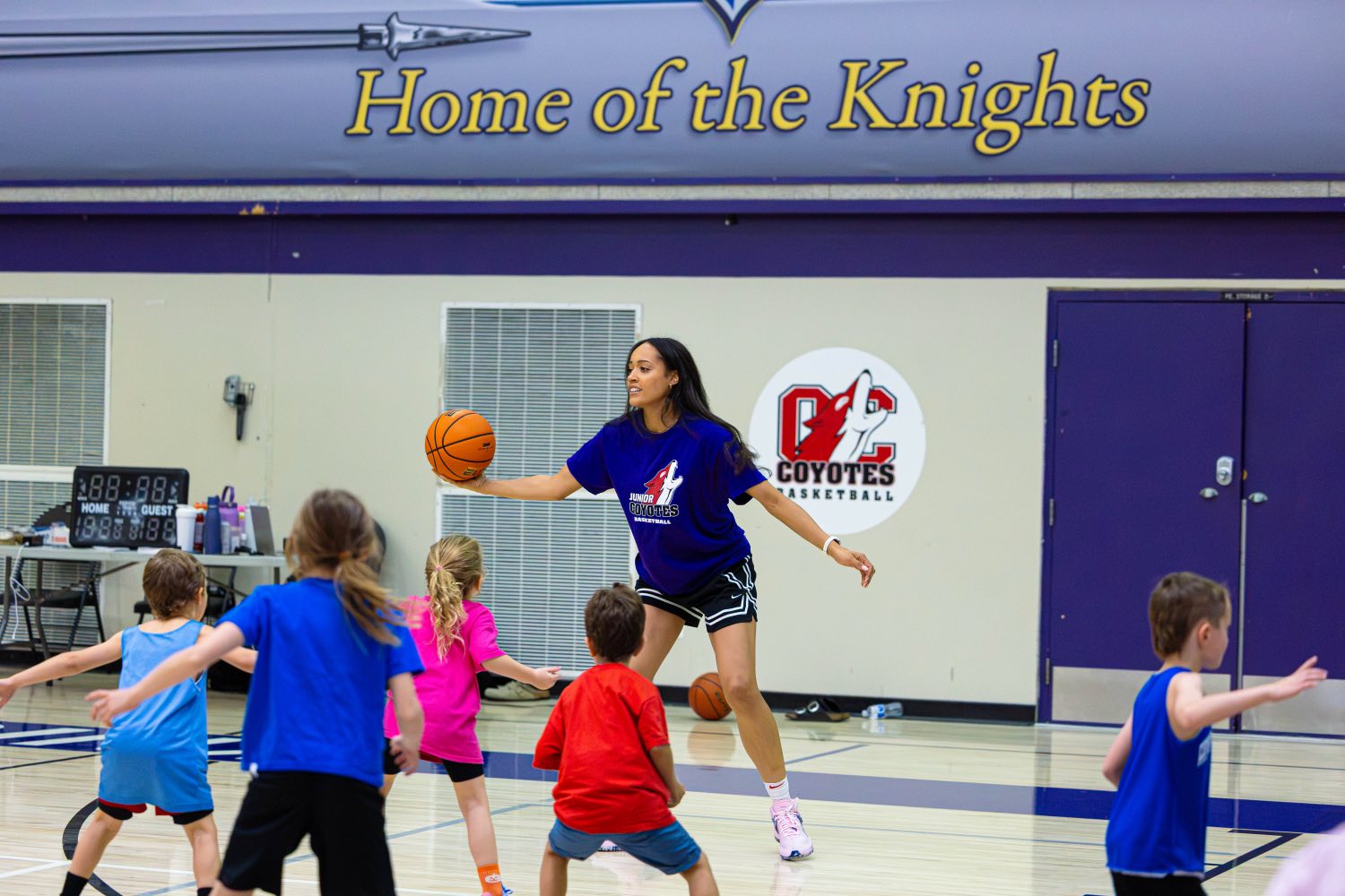WNBA player Nayo Raincock-Ekunwe running a drill with the Junior Coyotes girls group